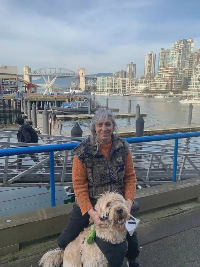 Dr. Balsara with a dog on the Vancouver waterfront